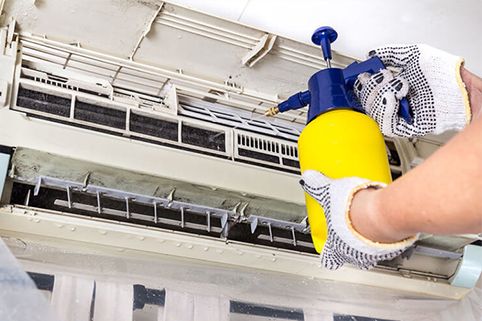 An air conditioner with front cover flipped up.